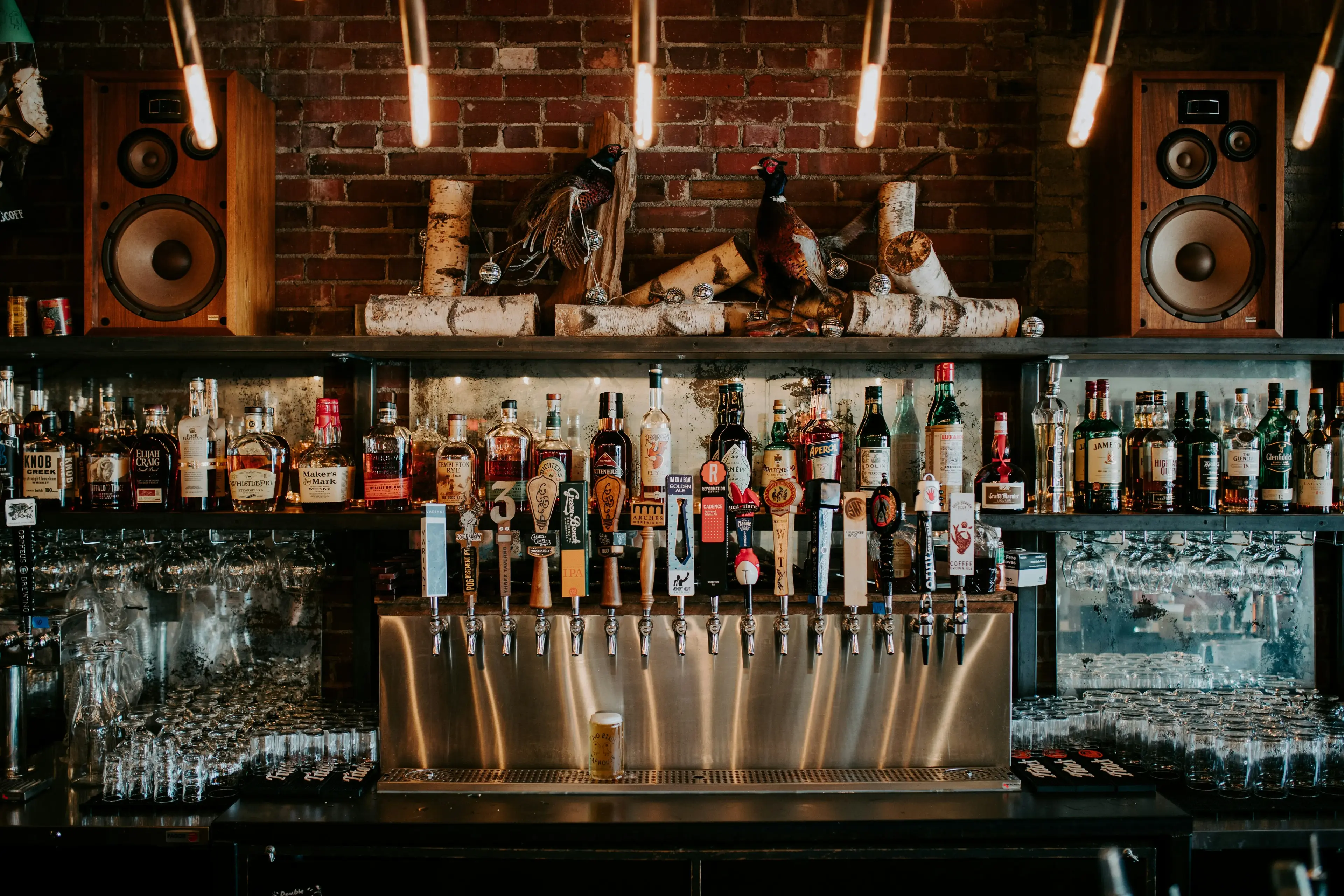 Craft beer taps at a brick bar