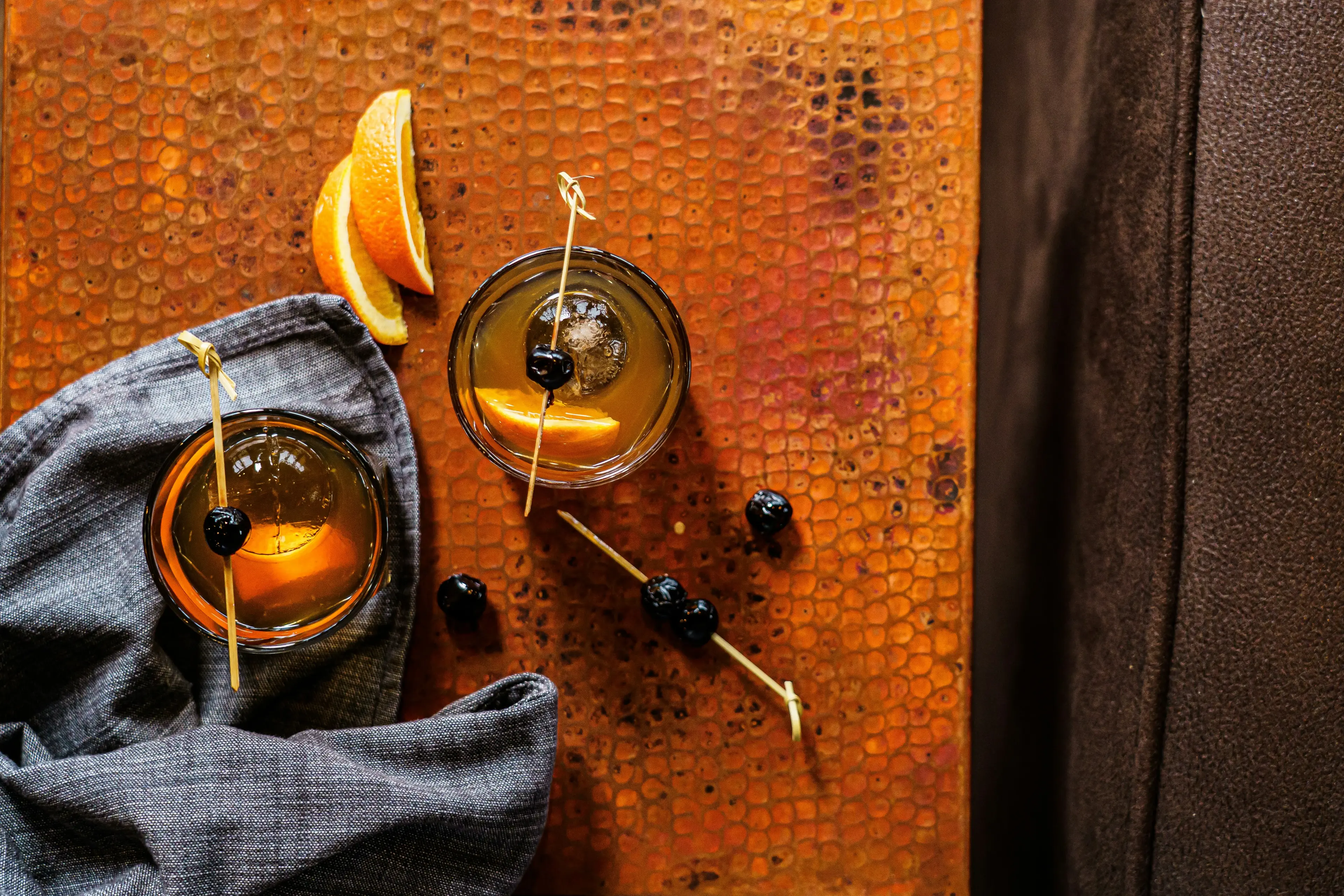 Old fashioned cocktails on a copper bar top