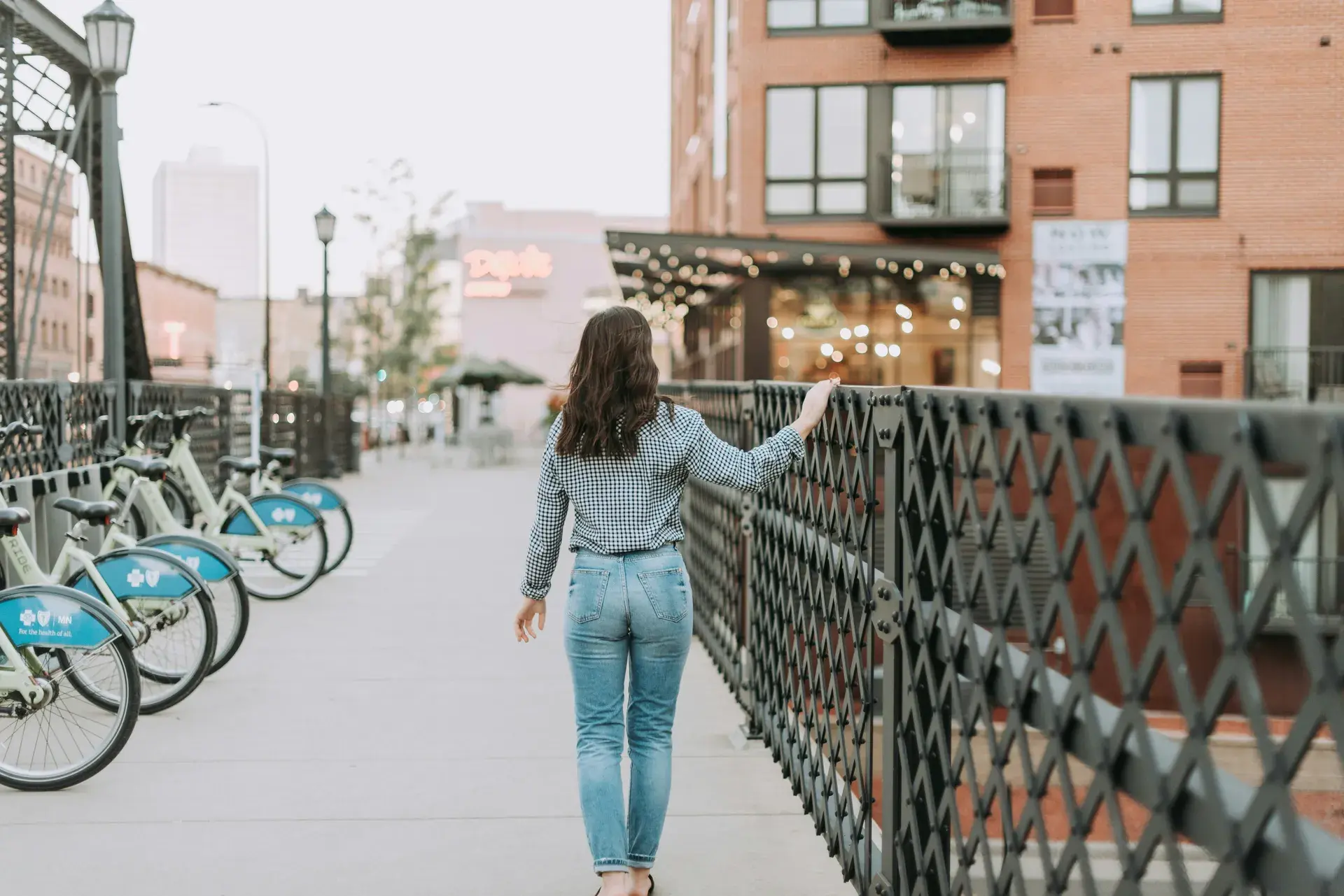 Evening view of the North Loop walkway with bike share stations and warm lighting