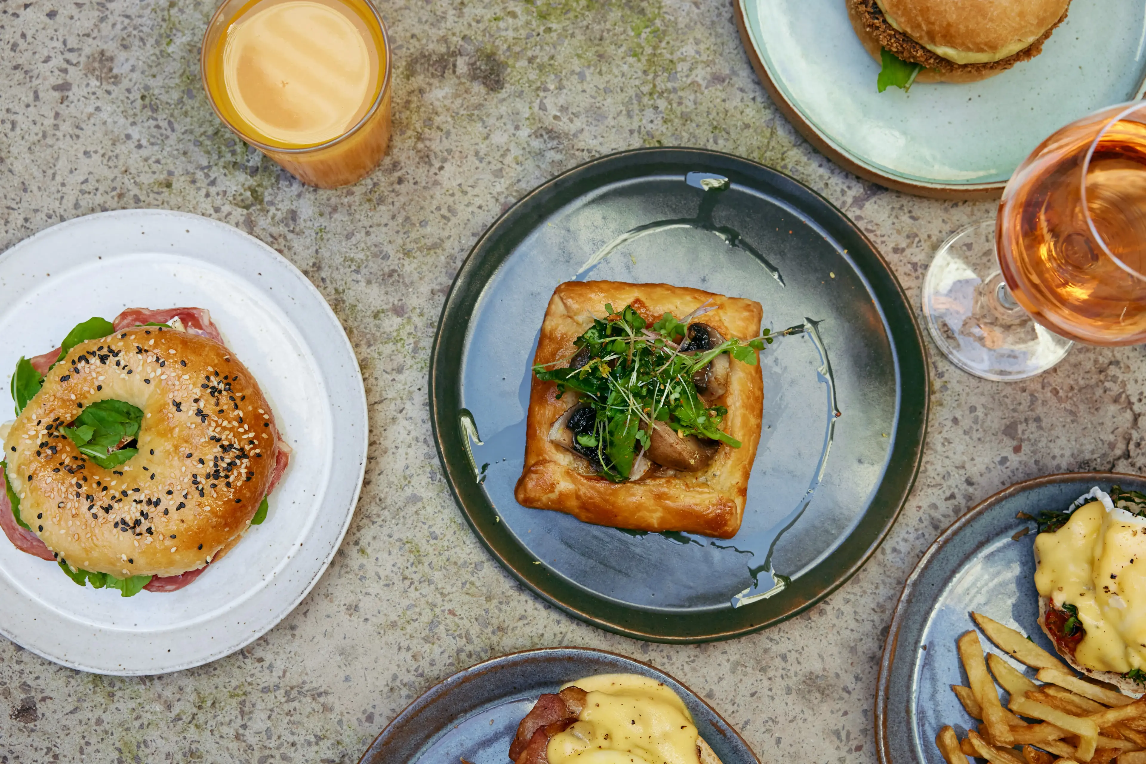 Bakery spread with pastries, bagels, and brunch items