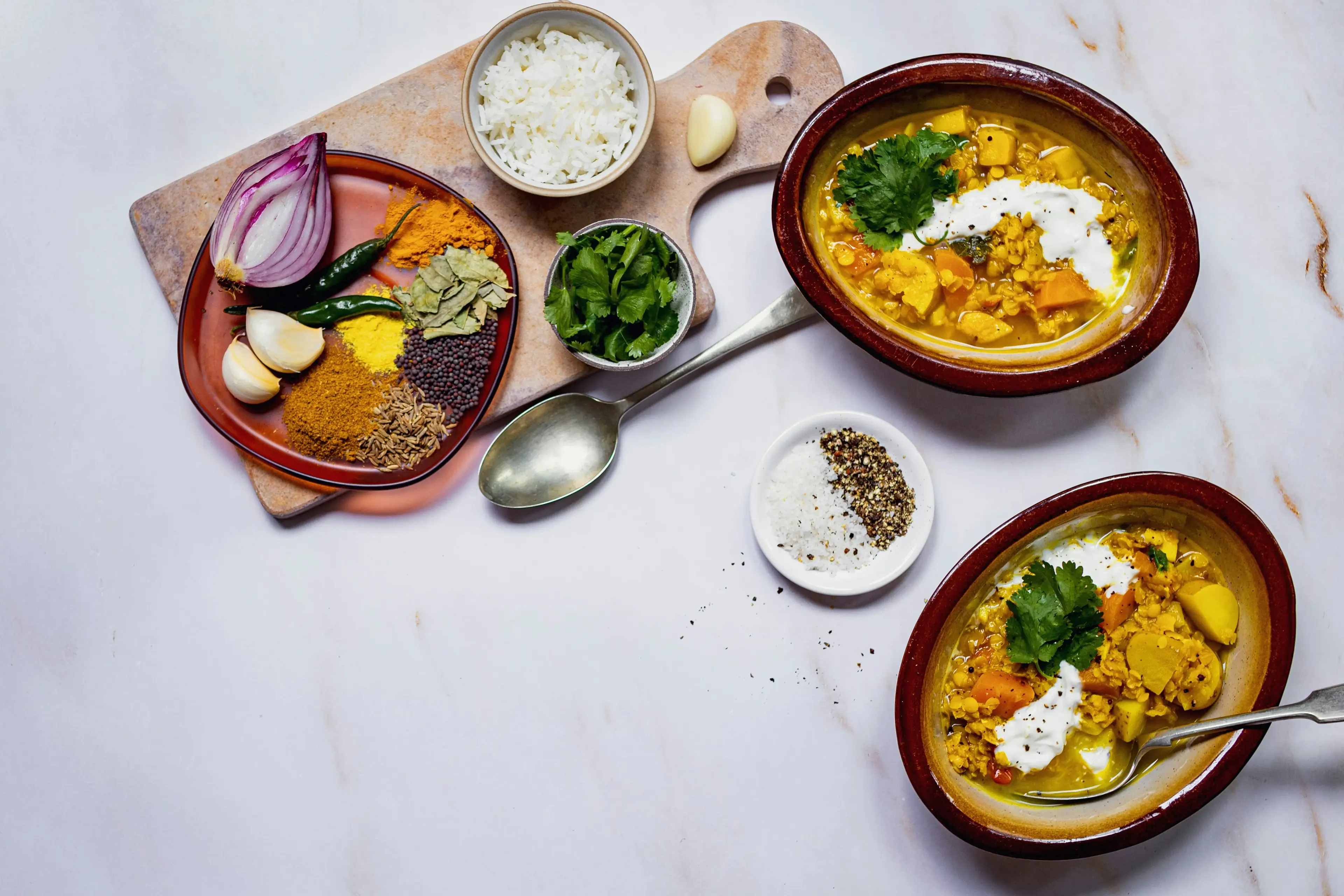 Indian curry with spices and rice bowls