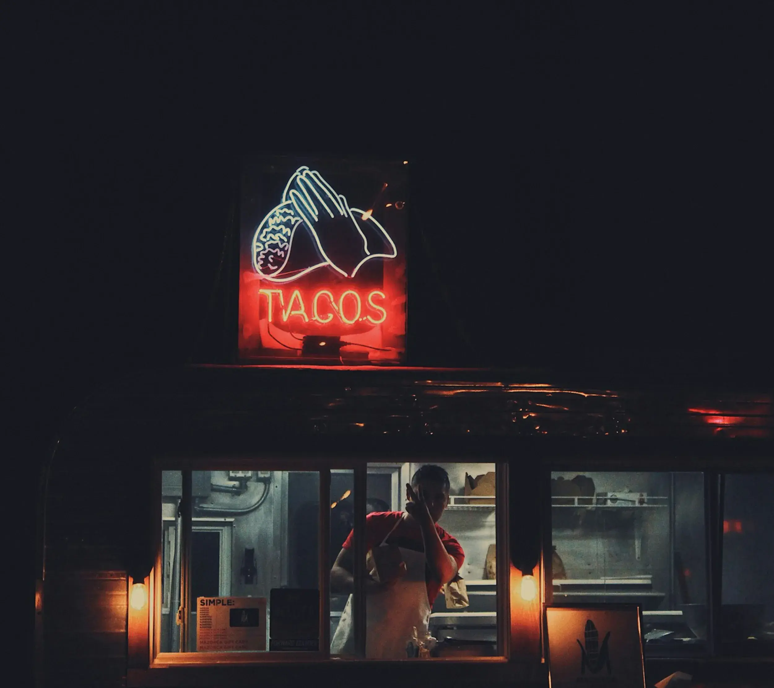 Taco neon sign glowing at night