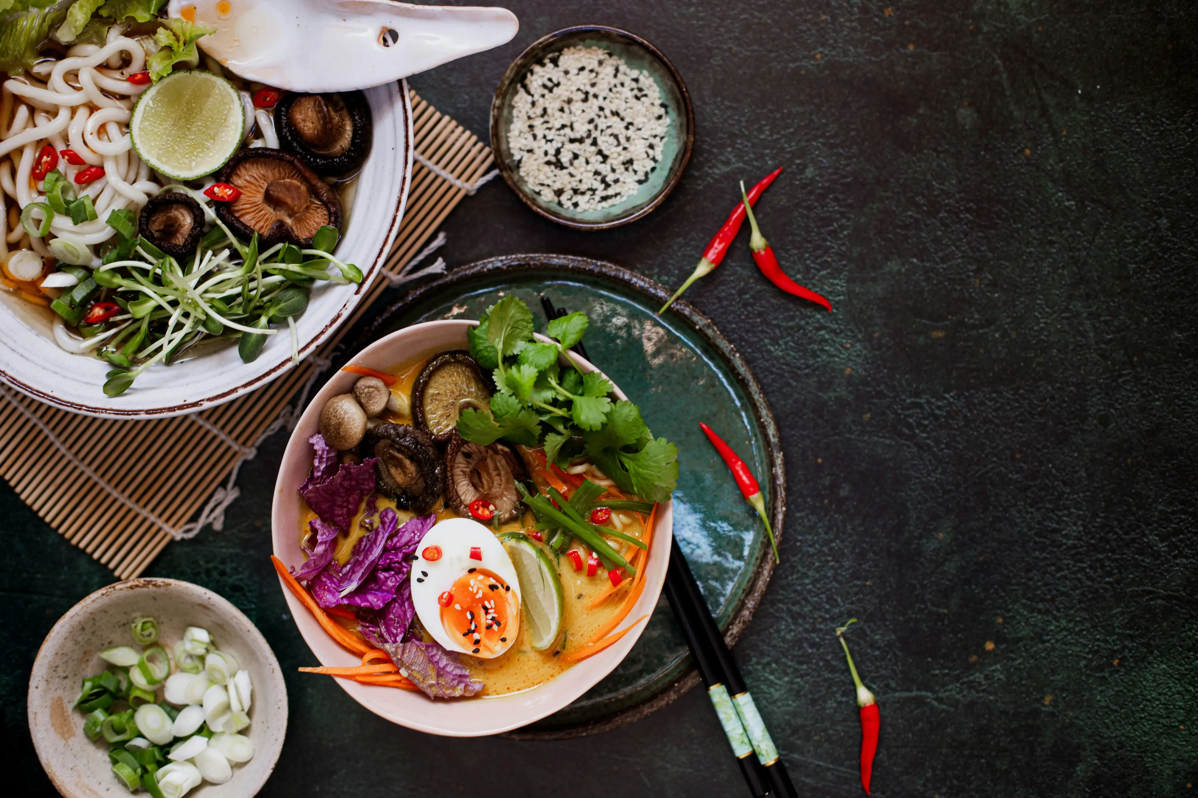 Vietnamese pho bowls with herbs and chili